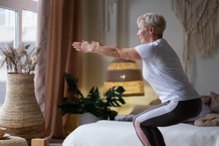 Senior,Caucasian,Woman,Practicing,Advanced,Yoga,Chair,Pose,Or,Utkatasana