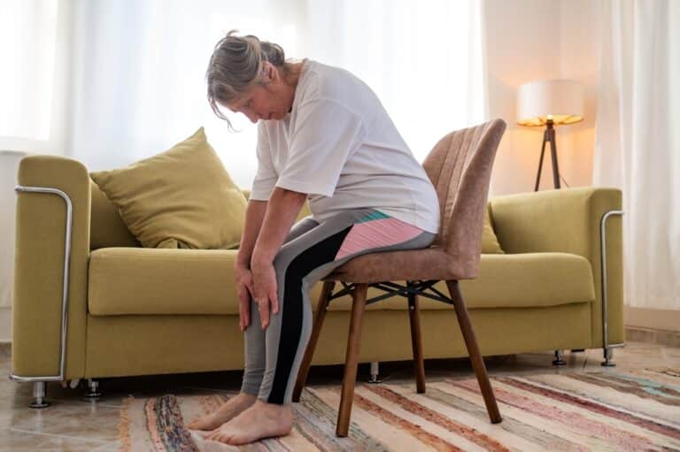 Senior,Caucasian,Woman,Doing,Doing,Yoga,At,Home,On,Sofa